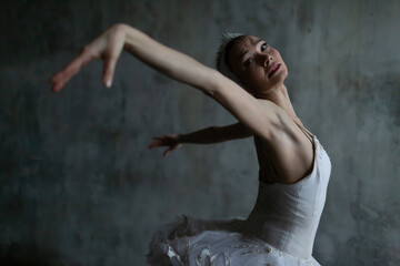 Slender ballerina in the image of Odette from Pyotr Tchaikovsky's ballet "Swan Lake"
