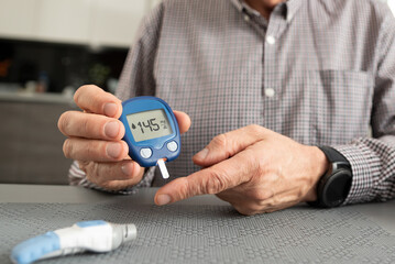 Man measures his blood sugar. Diabetes concept