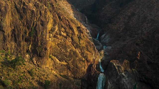 Aerial view of waterfall in rocky terrain, Socotra Island, Yemen.