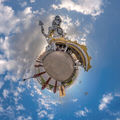 Fototapeta na wymiar tallest hindu shiva statue in india on mountain near ocean on little planet in blue sky with evening clouds, transformation of spherical 360 panorama. Spherical abstract view with curvature of space.