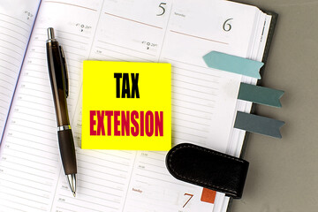 TAX EXTENSION text sticky on dairy on gray background
