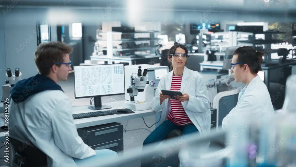 Poster female medical supervisor having a conversation with two young scientist about a gene editing resear