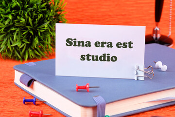 Sina era est studio It means Without anger and addiction on a white business card standing on a...