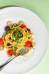  Agretti pasta spaghetti. Barba di frate or Saltwort or Salsola Soda, olives, anchovy, tomatoes, capers,  pine nuts and olive oil, spring Italian recipes, spring Easter recipes. Light mint green  back