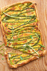 Asparagus pie or tart with eggs, cheese and aromatic herbs, spring Easter recipes. French healthy cuisine, Provencal herbs. Spring asparagus