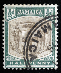 Ukraine, Kiyiv - February 3, 2024.An carmine postage stamp showing Arms of Jamaica. Jamaica is an island country situated in the Caribbean Sea. Philately. - obrazy, fototapety, plakaty