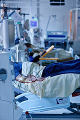 Patient in the ICU in a hospital with surgery equipment.