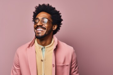 Obraz premium Portrait of a jovial afro-american man in his 20s wearing a chic cardigan while standing against pastel or soft colors background