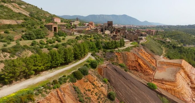 Aerial view of the former Monteponi mine, near Iglesias in Sardinia, Italy. The red color is due to the zinc and lead present in the soil. The mining plant is now closed. Mining concept.