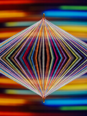 Converging Multi-colored Sewing Thread with motion blur effect on a rotating table, colorful background