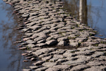 COBBLESTONE - Old stone road flooded by rain