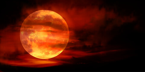 Red Moon, a real full moon in the dark cloudy sky with the moon's red light effect