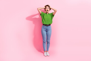 Full body portrait of speechless shocked lady arms touch head open mouth isolated on pink color background