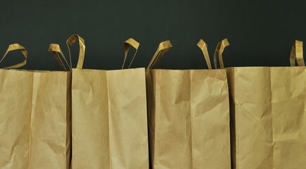Paper, cardboard shopping bags. Storage and use of bags. Packing groceries. Dark background. Copy...