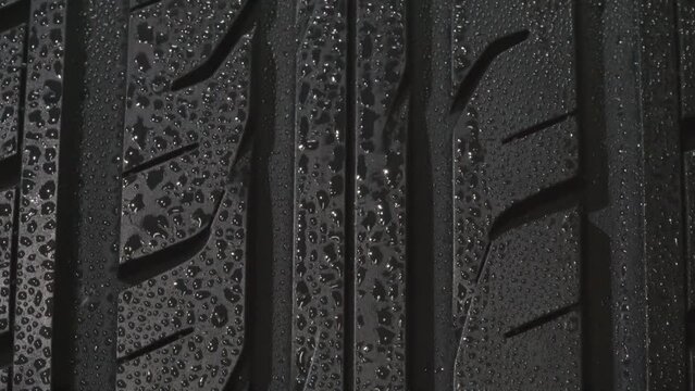 Wet Tire Treads with Water Droplets Close-Up