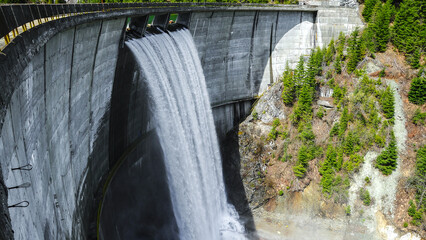 Galbenu dam during springtime. The water is overflowing the dam, forming a waterfall when spilling...