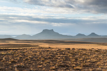 View of Wide uninhabited landscape with mountains of Jarlhettur in front of Langjokull glacier, highlands of Iceland.