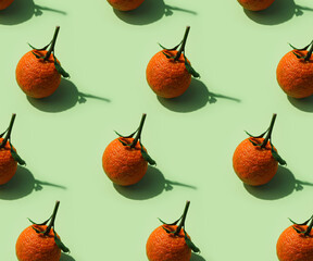 Pattern with Organic mandarine with leaves on green background
