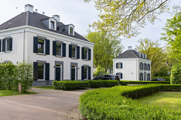 Modern white manor houses in suburban green area Dousberg in Maastricht in The Netherlands