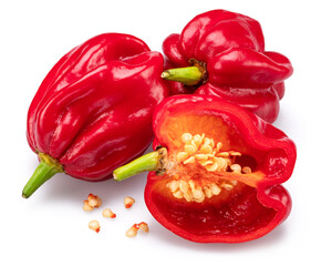 Red habaneros and sliced habanero pepper with seeds isolated on white background.