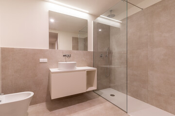 Fototapeta na wymiar Interior photo of the modern stylish bathroom in light beige colors