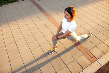 Woman stretching out before morning jogging