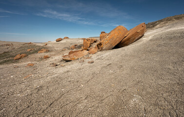 Large round broken red concretion on a hillside at Red Rock Coulee near Seven Persons, Alberta, Canada - obrazy, fototapety, plakaty