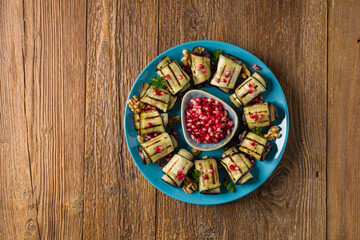 Delicious appetizer of grilled eggplants. Wrapped in rolls with nut paste. Served with pomegranates. - 788206935