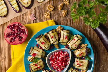 Delicious appetizer of grilled eggplants. Wrapped in rolls with nut paste. Served with pomegranates. - 788206996