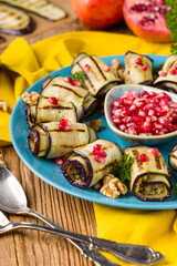 Delicious appetizer of grilled eggplants. Wrapped in rolls with nut paste. Served with pomegranates. - 788207132