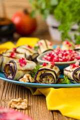 Delicious appetizer of grilled eggplants. Wrapped in rolls with nut paste. Served with pomegranates. - 788207310