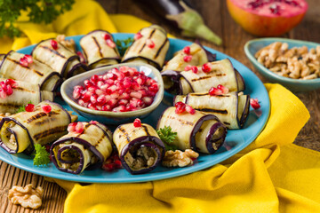 Delicious appetizer of grilled eggplants. Wrapped in rolls with nut paste. Served with pomegranates. - 788207336