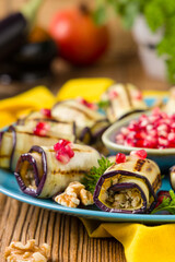 Delicious appetizer of grilled eggplants. Wrapped in rolls with nut paste. Served with pomegranates. - 788207381