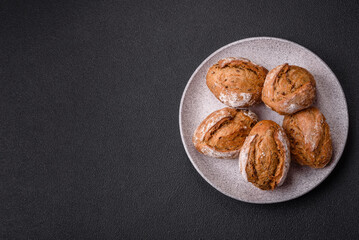Fresh baked bread buns with salt, spices, seeds and grains