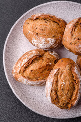 Fresh baked bread buns with salt, spices, seeds and grains