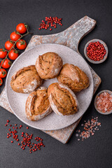 Fresh baked bread buns with salt, spices, seeds and grains