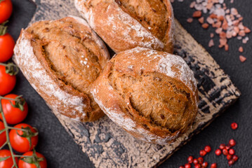 Fresh baked bread buns with salt, spices, seeds and grains