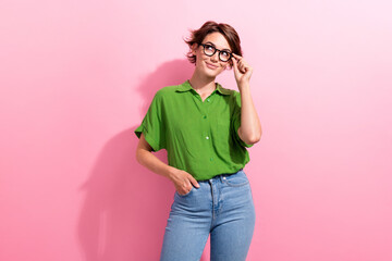 Photo of dreamy charming young woman dressed green shirt hand eyewear looking empty space isolated...