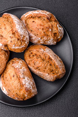 Fresh baked bread buns with salt, spices, seeds and grains