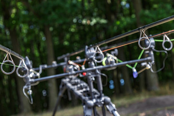 Carpfishing session at the Lake.Carp fishing rods standing on special tripods.Scenic landscape...