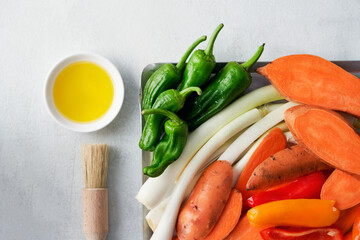 Raw, fresh assorted vegetables for grilling or baking: sweet potato, red and green bell peppers,Summer Onions. Top view. Healthy food.