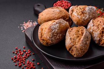 Fresh baked bread buns with salt, spices, seeds and grains