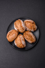 Fresh baked bread buns with salt, spices, seeds and grains