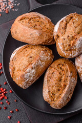Fresh baked bread buns with salt, spices, seeds and grains