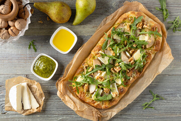 Traditional Roman pinsa with pear, nuts and arugula