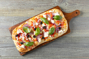 Traditional Roman pinsa with feta cheese, peppers and black olives. - 788209991