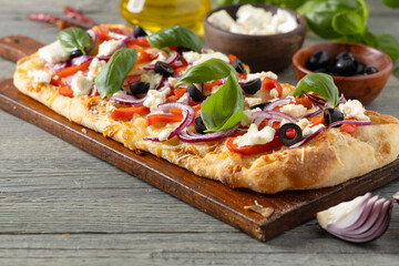 Traditional Roman pinsa with feta cheese, peppers and black olives. - 788210157