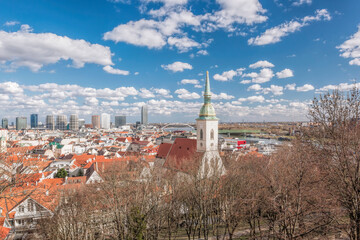 Bratislava cityscape view with old church against modern skyscrapers next to Danube river and old town in Slovakia.