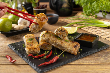 Portion of spring rolls stuffed with meat. Served with sauce. - 788211595