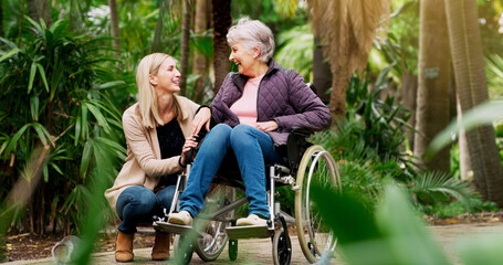 Smile, woman and senior mother in wheelchair at park for conversation, retirement and help for support. Daughter, mom and person with a disability in garden for love, laugh and happy family bonding